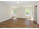 A bright and spacious bedroom features hardwood floors, and multiple windows for natural light at 4203 Ethel Sustar Dr, Monroe, NC 28110