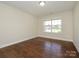 Simple bedroom features a window overlooking the front yard and hard surface flooring at 4203 Ethel Sustar Dr, Monroe, NC 28110