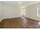 Bright bedroom featuring hardwood floors, natural light from windows, and neutral wall paint at 4203 Ethel Sustar Dr, Monroe, NC 28110
