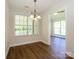 Dining room with a modern chandelier and a view into the living room at 4203 Ethel Sustar Dr, Monroe, NC 28110