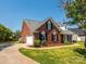 Charming brick home featuring black shutters, manicured landscaping and attached garage at 4203 Ethel Sustar Dr, Monroe, NC 28110