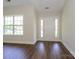 Bright foyer with wood floors, white door, and ample natural light streaming in from a large window at 4203 Ethel Sustar Dr, Monroe, NC 28110