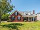Charming brick home with a well-manicured lawn, dormer windows, and a cozy front porch at 4203 Ethel Sustar Dr, Monroe, NC 28110