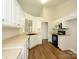 Well-lit kitchen with white cabinets, laminate countertops, stainless appliances and hard surface floors at 4203 Ethel Sustar Dr, Monroe, NC 28110