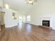 Open-concept living room featuring wood floors, a fireplace, and a vaulted ceiling with ceiling fan at 4203 Ethel Sustar Dr, Monroe, NC 28110