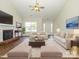 Staged living room with a fireplace, neutral furniture, and a large area rug at 4203 Ethel Sustar Dr, Monroe, NC 28110