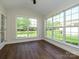 Bright sun room featuring large windows and wood-look flooring, perfect for relaxing and enjoying the view at 4203 Ethel Sustar Dr, Monroe, NC 28110