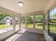 The sunroom is surrounded by large windows to enjoy the scenic backyard views at 4203 Ethel Sustar Dr, Monroe, NC 28110