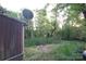 View of the home's wooded backyard and garden area with plants, providing a natural setting at 4814 Chapel Grove Rd, Gastonia, NC 28052