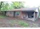 A single-story brick home with blue shutters, showcasing the side entrance and yard at 4814 Chapel Grove Rd, Gastonia, NC 28052