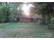 A single-story brick home with a large front yard and mature trees, capturing its curb appeal at 4814 Chapel Grove Rd, Gastonia, NC 28052