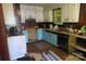 Dated kitchen featuring blue-painted cabinets and a worn floor, ready for renovation at 4814 Chapel Grove Rd, Gastonia, NC 28052