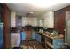 An outdated kitchen with mixed wood and white cabinets, needing renovation at 4814 Chapel Grove Rd, Gastonia, NC 28052