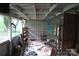 A partially-finished sunroom or storage area with exposed beams and natural light, awaiting customization at 4814 Chapel Grove Rd, Gastonia, NC 28052