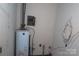 Utility Room featuring a water heater and electrical panel in need of repair at 4814 Chapel Grove Rd, Gastonia, NC 28052