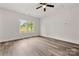 Bright, light-filled bedroom with new flooring, a ceiling fan and a view of the backyard at 508 Clegg St, Shelby, NC 28150