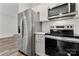 Modern kitchen with stainless steel appliances, white subway tile backsplash, and gray cabinets at 508 Clegg St, Shelby, NC 28150