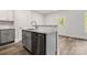 Kitchen island with gray cabinets, marble countertop, and stainless steel dishwasher at 508 Clegg St, Shelby, NC 28150