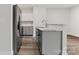 Modern kitchen features gray cabinets, stainless steel appliances, marble counters, and wood flooring at 508 Clegg St, Shelby, NC 28150