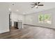 Open-concept kitchen and living space with new flooring, fresh paint, and large windows at 508 Clegg St, Shelby, NC 28150
