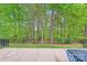 Backyard featuring a patio and a wooded landscape, perfect for privacy at 5150 Mount Clare Ln, Charlotte, NC 28210