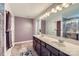 Bathroom featuring a double vanity with dark wood cabinets and a large mirror at 5150 Mount Clare Ln, Charlotte, NC 28210