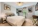 Bedroom featuring a bed with many decorative pillows and contemporary art on the walls at 5150 Mount Clare Ln, Charlotte, NC 28210