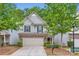 Charming two-story home featuring stone accents, gray siding, a well-manicured lawn and a two car garage at 5150 Mount Clare Ln, Charlotte, NC 28210