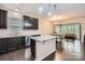 Modern kitchen with dark wood cabinets, granite countertops, a center island, and stainless steel appliances at 5150 Mount Clare Ln, Charlotte, NC 28210