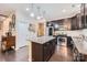 Well-equipped kitchen with stainless steel appliances, granite countertops, dark wood cabinets, and kitchen island at 5150 Mount Clare Ln, Charlotte, NC 28210