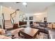 Open-concept living area with hardwood floors, staircase, stylish furniture, and seamlessly connected kitchen at 5150 Mount Clare Ln, Charlotte, NC 28210