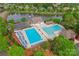 Aerial view of a community pool and clubhouse, with landscaping, seating, and parking at 536 Wellbourne Nw Ct, Concord, NC 28027