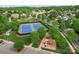Aerial view of community tennis courts and playground set among mature trees and well-maintained landscaping at 536 Wellbourne Nw Ct, Concord, NC 28027