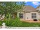 Charming backyard featuring green lawn, well-manicured shrubs, a white fence, and covered porch at 536 Wellbourne Nw Ct, Concord, NC 28027
