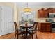 Cozy dining area with a round table, hardwood floors, and ample natural light at 536 Wellbourne Nw Ct, Concord, NC 28027