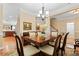Traditional dining room featuring a large wooden table, seating for six and crown molding at 536 Wellbourne Nw Ct, Concord, NC 28027