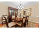 Dining room features a hutch, chandelier, large table, and seating for six at 536 Wellbourne Nw Ct, Concord, NC 28027