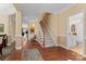 Grand foyer with hardwood floors, staircase, and elegant trim details at 536 Wellbourne Nw Ct, Concord, NC 28027