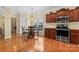 Eat-in kitchen features wooden cabinets, stainless steel appliances and a window overlooking flowers outside at 536 Wellbourne Nw Ct, Concord, NC 28027