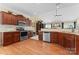 Well-equipped kitchen with stainless steel appliances, wood cabinets, and hardwood floors at 536 Wellbourne Nw Ct, Concord, NC 28027
