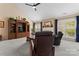 Comfortable living room featuring vaulted ceilings, plush seating and a large media center at 536 Wellbourne Nw Ct, Concord, NC 28027