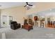 Open living room with high ceilings features a comfortable leather recliner and access to the backyard at 536 Wellbourne Nw Ct, Concord, NC 28027