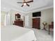 Bright main bedroom featuring a ceiling fan, TV, and tasteful wooden dresser at 536 Wellbourne Nw Ct, Concord, NC 28027