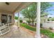 Covered patio with white columns and stone flooring overlooking the manicured lawn and landscaping at 536 Wellbourne Nw Ct, Concord, NC 28027