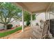Covered patio with stone flooring and white columns, providing a scenic view of the landscaped backyard at 536 Wellbourne Nw Ct, Concord, NC 28027