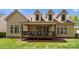 View of a spacious backyard with a covered deck, perfect for outdoor entertaining and relaxation at 541 Nw Sutro Forest Dr, Concord, NC 28027