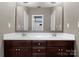 Bathroom featuring double sinks with granite countertop vanity and large mirror at 541 Nw Sutro Forest Dr, Concord, NC 28027