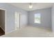 Carpeted bedroom with standard closet, ceiling fan, and natural light at 541 Nw Sutro Forest Dr, Concord, NC 28027