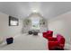 Cozy bonus room featuring an arched ceiling, natural light, and comfortable seating at 541 Nw Sutro Forest Dr, Concord, NC 28027