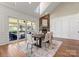 Elegant dining room featuring a stone fireplace, skylight, and sliding door access to deck at 541 Nw Sutro Forest Dr, Concord, NC 28027